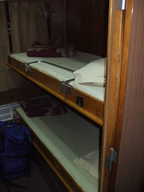 Three bunks or berths inside a Bulgarian sleeper or pullman passenger car.