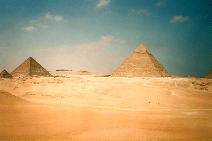 Looking back to the Great Pyramids of Giza from out in the desert.