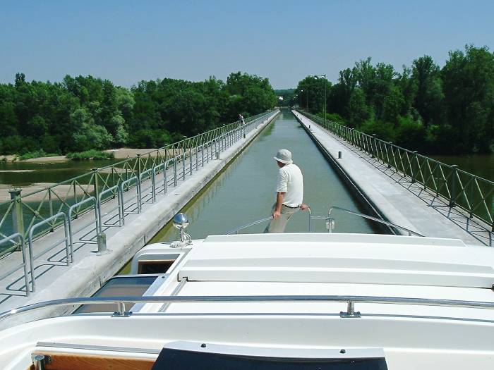Exiting a lock onto a canal bridge over a river.