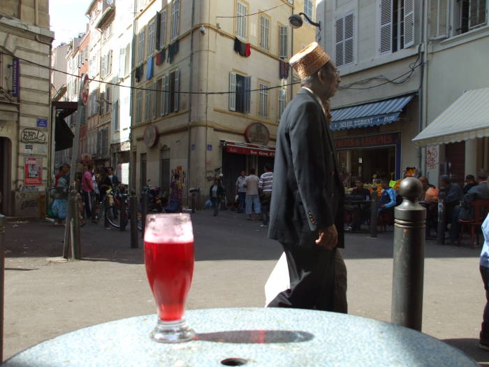 Watching the crowds pass while seated at le Grand Bar Vacon in the market district of Marseille.