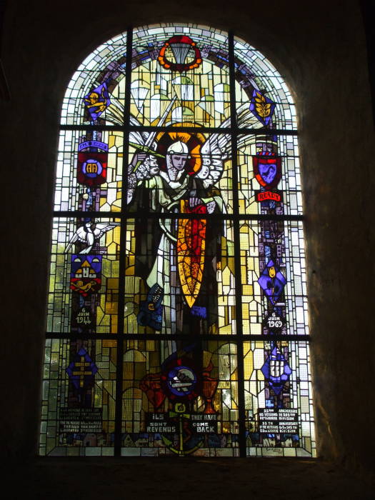 Stained glass window with paratroopers flanking Mary and Jesus, in Normandy.