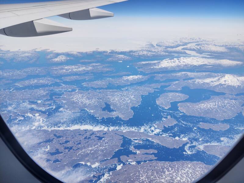 Flying across southern Greenland from north of Prince Christian Sound to just south of Qaqortoq, approaching the Labrador Sea, on board AF 136 2022-05-19. Qaqortoq barely visible near the center.