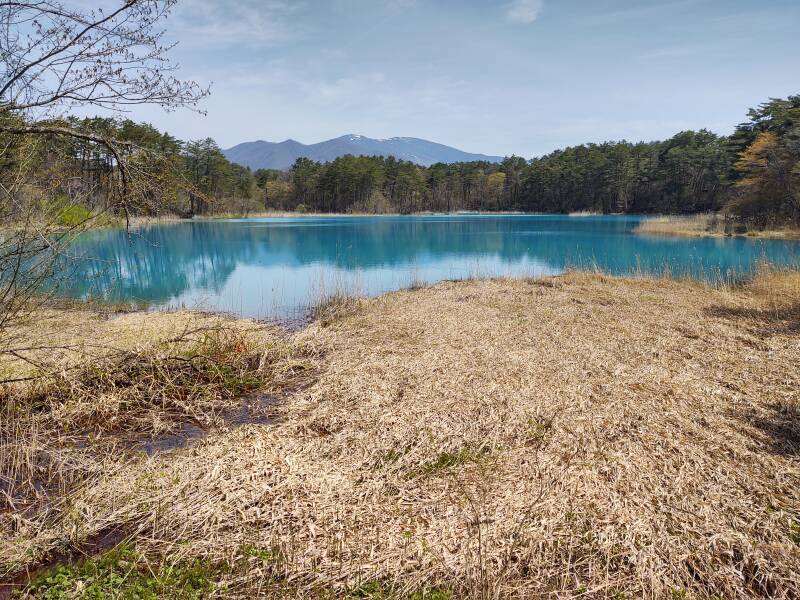 Benten-numa Pond with peaks of Mount Nishi-Daiten, Mount Nishi-Azumayama, and Mount Yanabe in the distance.
