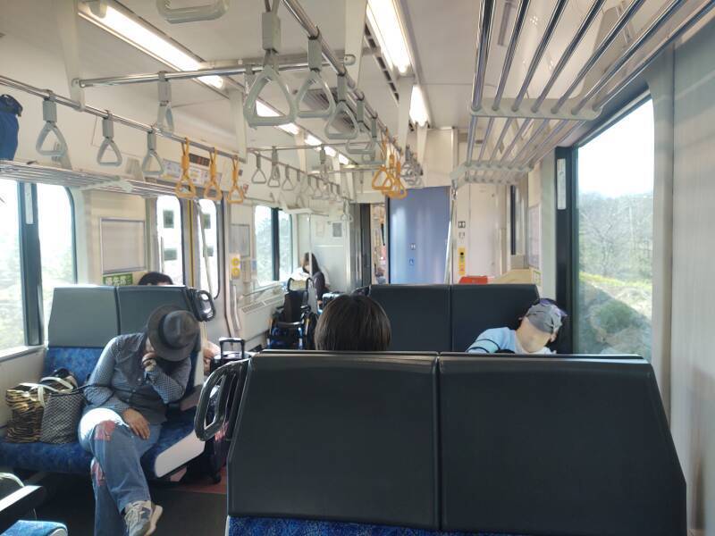 Passengers sleeping on board a Ban-Etsusai Line train making local stops from Kōriyama Station to Aizu-Wakamatsu.