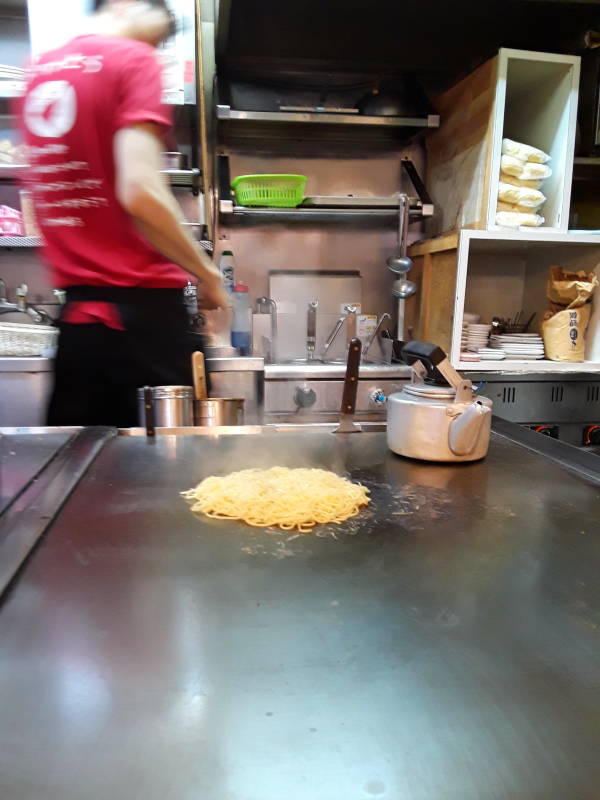 Okonomiyaki chef in Hiroshima, noodle base.