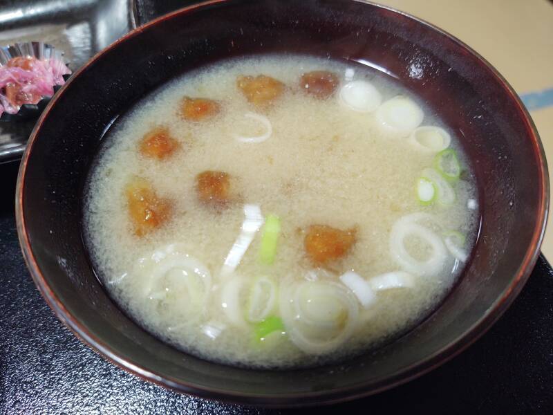 Miso soup with mushrooms and onions.