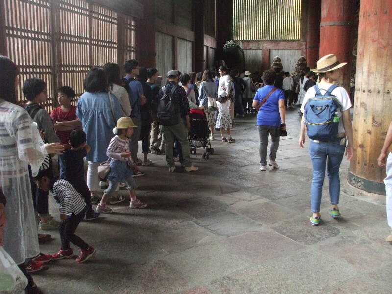 People waiting in line for their children to crawl through the pillar at Tōdai-ji, the Buddhist temple in Nara.