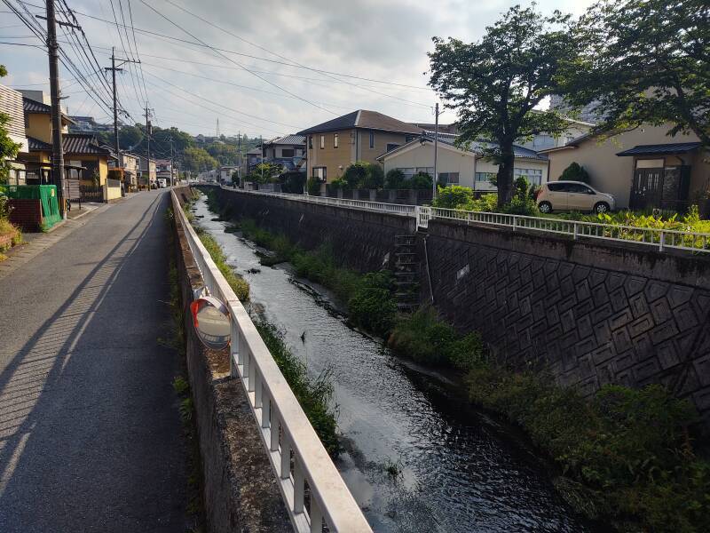 Walking from Ōita Station to the Furumiya tomb, along a small canal through a residential area.
