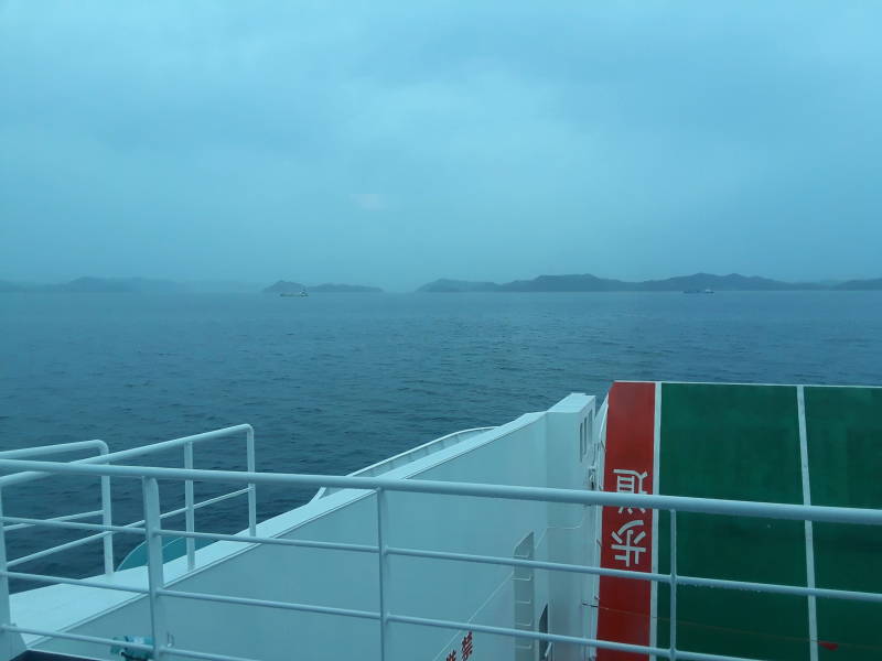 Other islands and the Honshū coast in the distance.