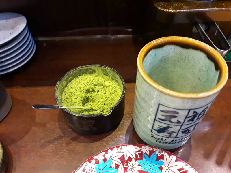 Matcha or green tea powder at the Sushi Train or Sushi-Go-Round or Conveyor Belt Sushi, in Asakusa, Tōkyō, Japan.