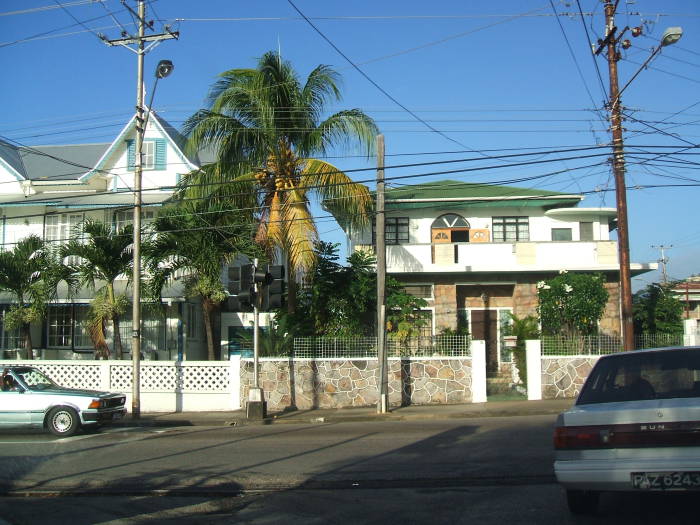 Riding a taxi to work in Trinidad:  Tropical homes, palm trees, and electrical poles.