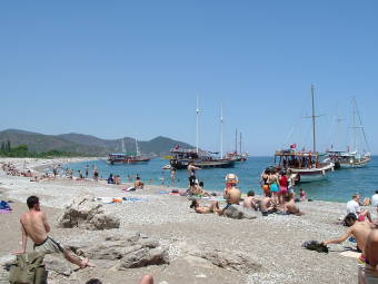Beach at Olimpos, Turkish sailboats and swimmers.