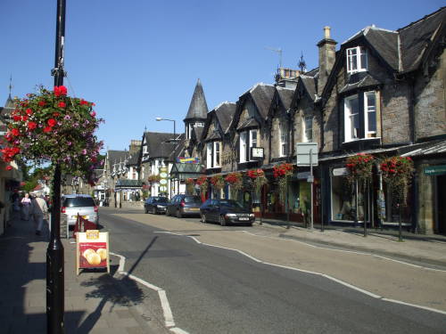 High Street through Pitlochry, Scotland, Pitlochry Backpackers at center.