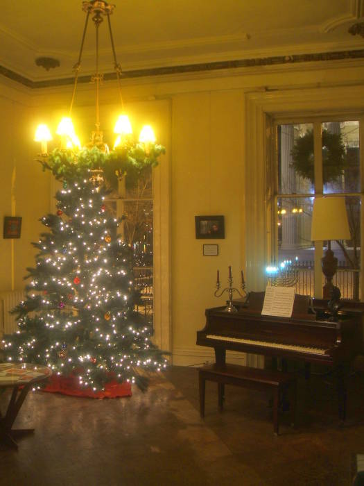 HI Baltimore hostel interior, living room with
					Christmas tree and grand piano.
