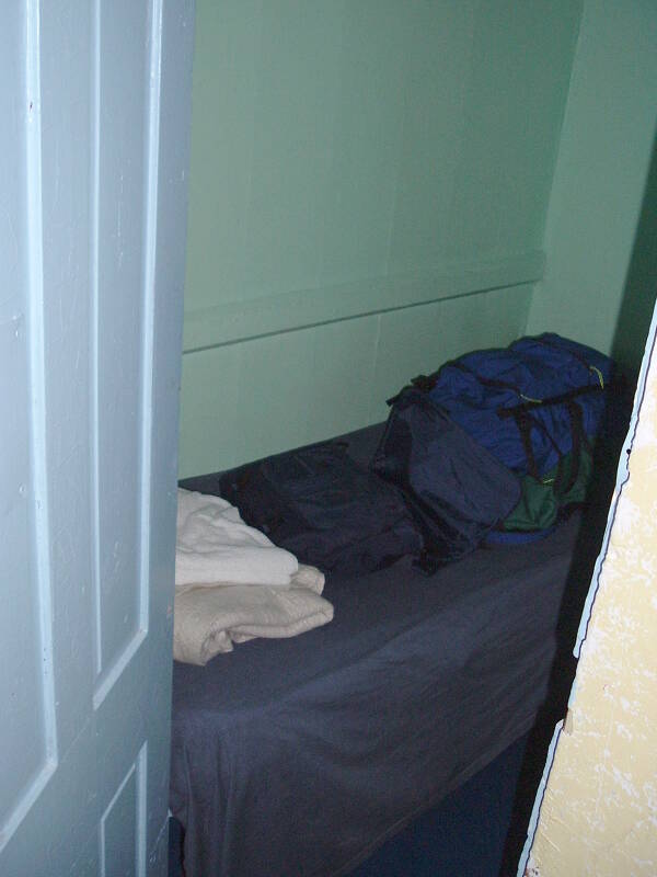 The bed in the cabin is a narrow shelf.