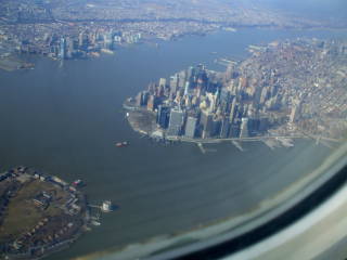 Arrive in New York by air and have an aerial view of Manhattan, Governor's Island, and Newark.