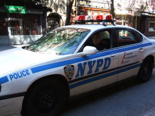 Two NYPD officers took me across town in a patrol car in a counterfeit currency investigation.