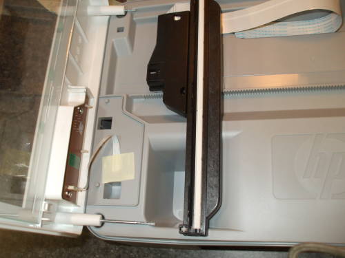 Hewlett-Packard Deskjet F380 partially disassembled, showing LED light on scanning carriage.
