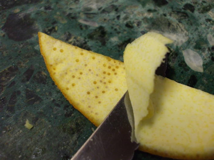 Cutting the pith from an orange peel.