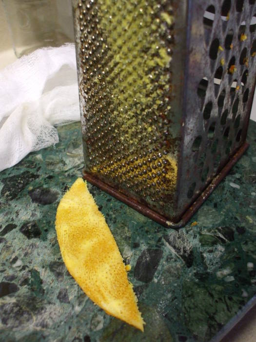 Grating the pith from the orange peel.