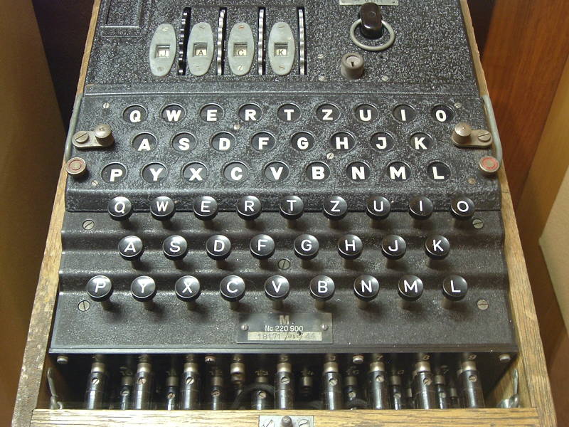 Close view of a 4-rotor Naval Enigma machine: Four rotors, light board, key board, plug board.