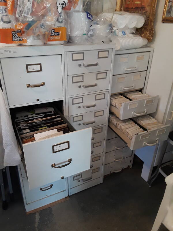 Three cabinets filled with dental records.