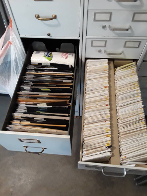 Three cabinets filled with dental records, a mix of cardstock, paper, x-ray film, and plastic film sleeves.