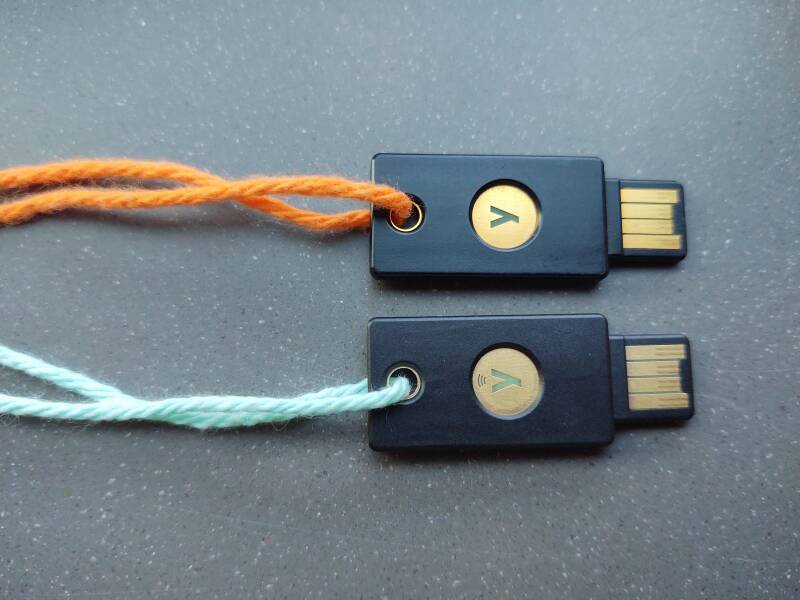 YubiKey 4 and YubiKey 5 devices on colored yarn.