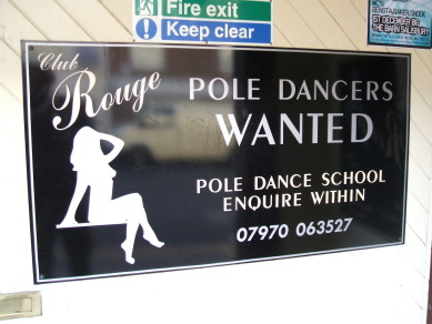Funny sign along the street in Salisbury, England.  School for strippers.  Pole dancing school.