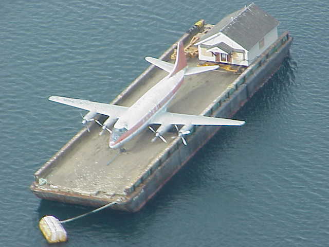 Plane being transported on a barge.