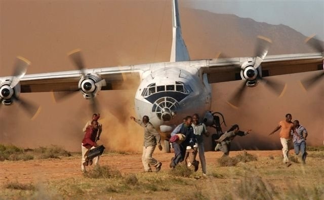 C130 cargo aircraft landing on a remote air strip in Africa.
