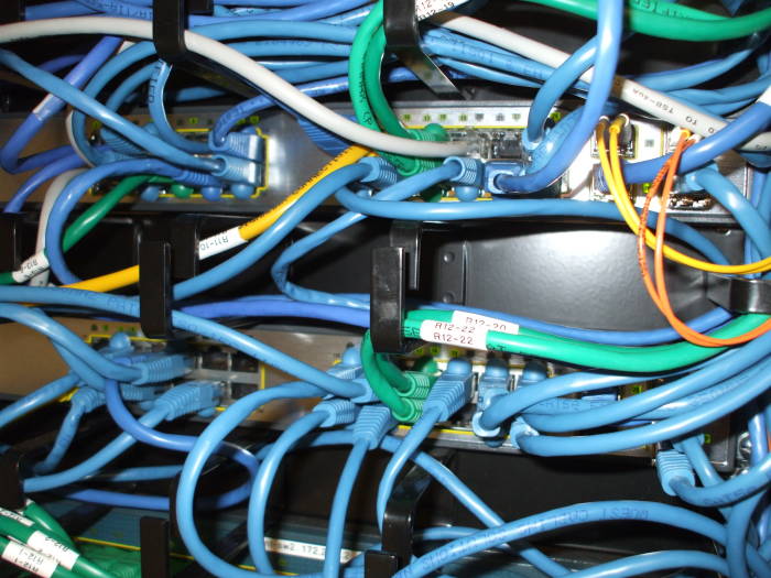 Category 6 (or cat-6) Ethernet cable plugging into Cisco switches.