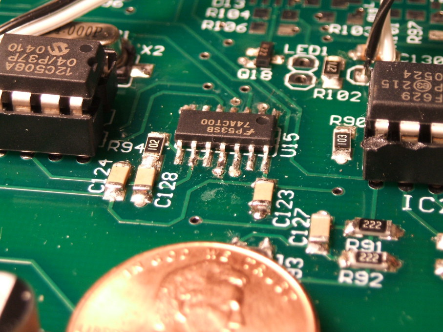 Integrated circuits, both DIP and SOIC, and other suface-mount components on a circuit board.  NorCal 2030 HF QRP transceiver construction.