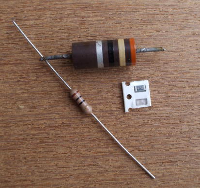 Three resistors:  29 ohm 2-watt power resistor, 10 ohm quarter-watt leaded or through-hole resistor, and 4700 ohm surface-mount resistor.