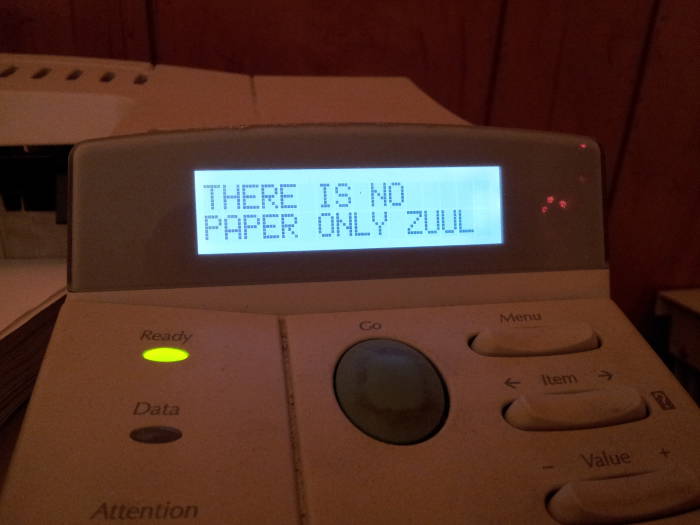 HP LaserJet printer displaying 'THERE IS NO PAPER ONLY ZUUL' as its ready message.