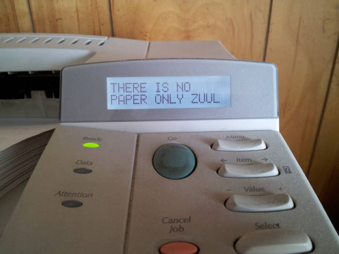 HP LaserJet printer displaying 'THERE IS NO PAPER ONLY ZUUL' as its ready message.