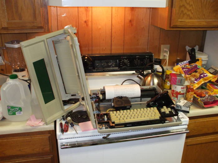 Smith-Corona Personal Word Processor or PWP, partially disassembled, sitting on a stove.