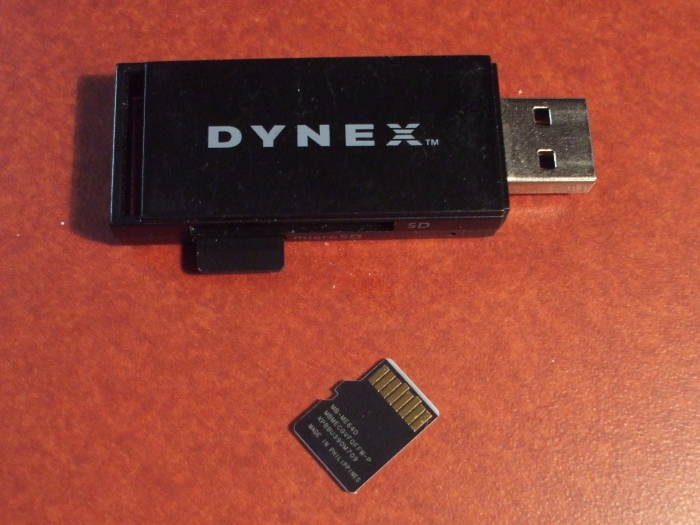 One flash memory chips in a USB carrier, another waiting to be copied.