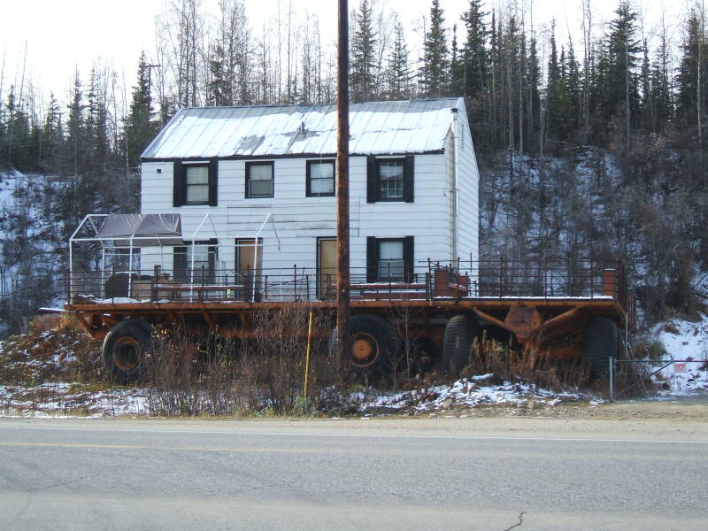 Eccentric house near the Alaska Pipeline just north of Fairbanks. Two tundra buggies and a radome.