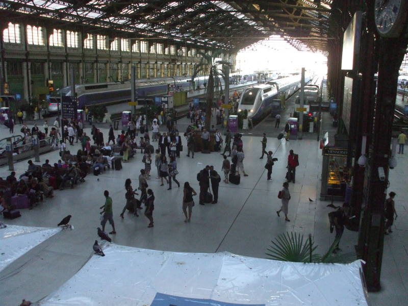 Passengers disembark at a large French train station:  Paris Gare de Lyon.