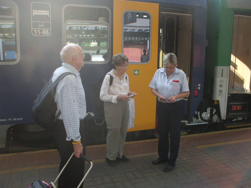 Showing the sleeping car tickets to the conductor of the City Night Line train in Praha hlavní nádraží.