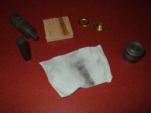 Stanley company grommet kit components, and leather piece.