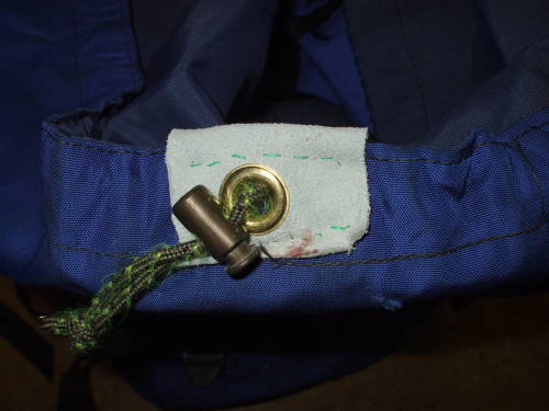 Drawstring passing through replacement grommet and leather reinforcement.