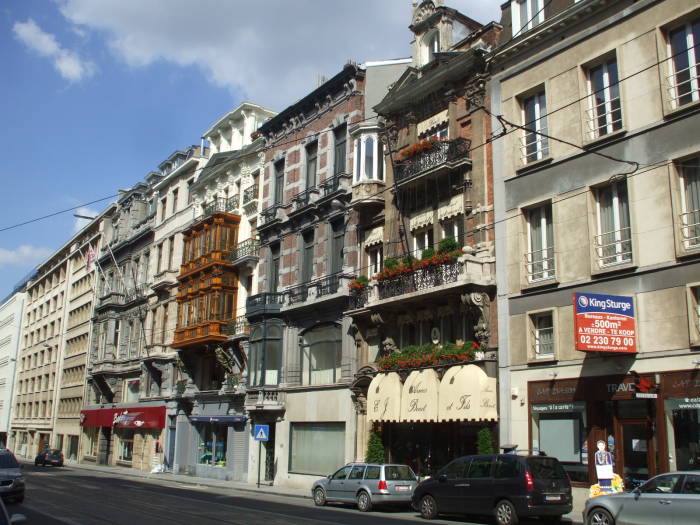 Art Nouveau architecture and an Belgian arms dealer along the Rue Royale in Brussels.