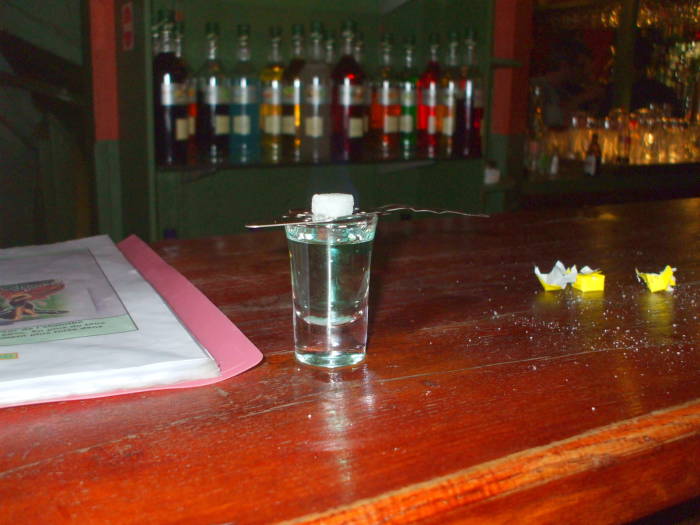A glass of absinthe with a sugar cube and slotted spoon in the Delirium Tremens absinthe bar in Brussels.