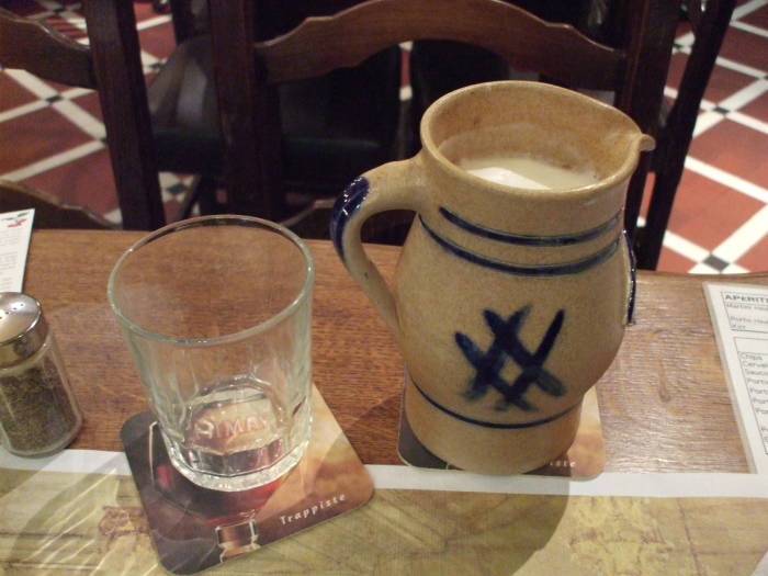 A small stoneware pichet of lambic biere blanc in À la Bécasse cafe in Brussels.