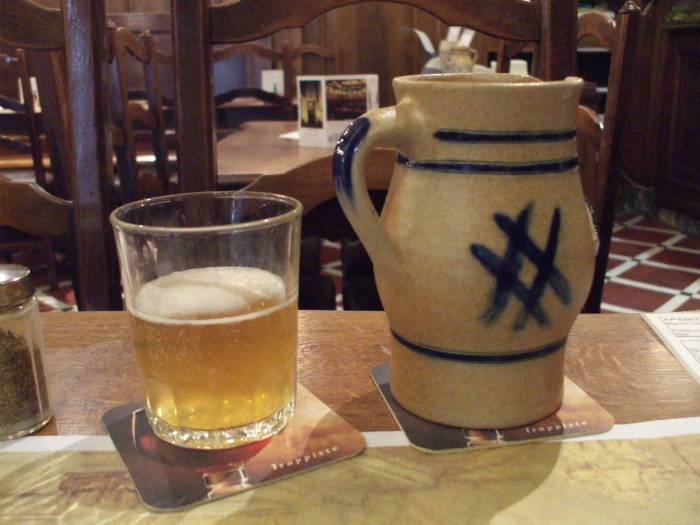 A small stoneware pichet of lambic biere blanc in À la Bécasse cafe in Brussels.