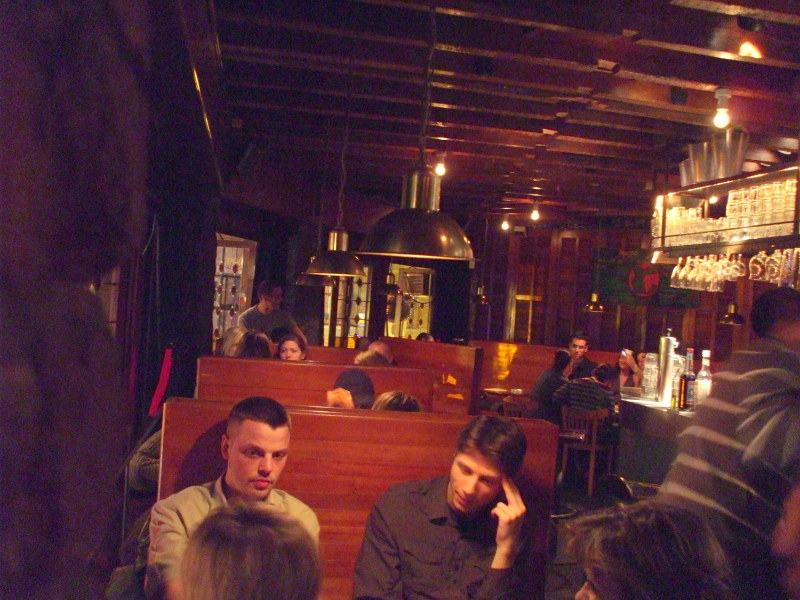 The upstairs bar area at the Mappa Mundo cafe in Brussels, at night.
