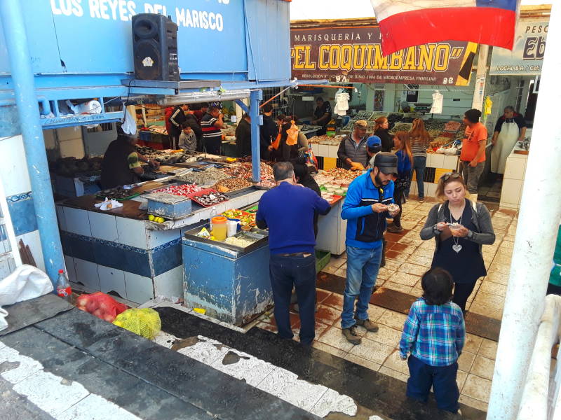 Local people sample food at the seafood market at the waterfront in Coquimbo.