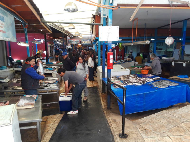 Local people sample food at the seafood market at the waterfront in Coquimbo.